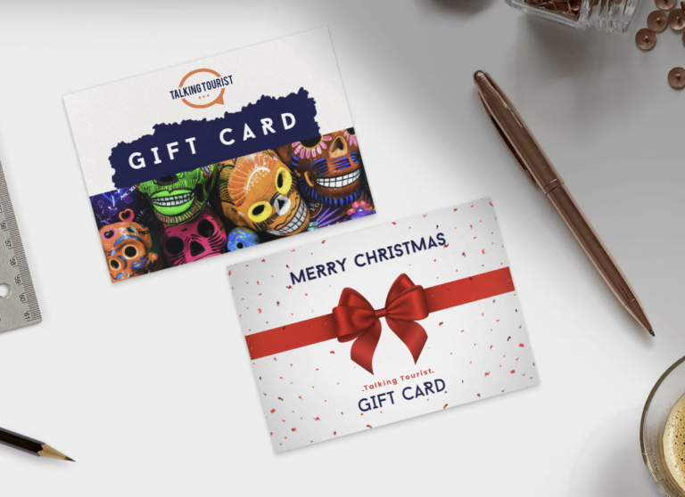 Showing 2 gift cards on a table, one with travel imagery and the other with Christmas imagery